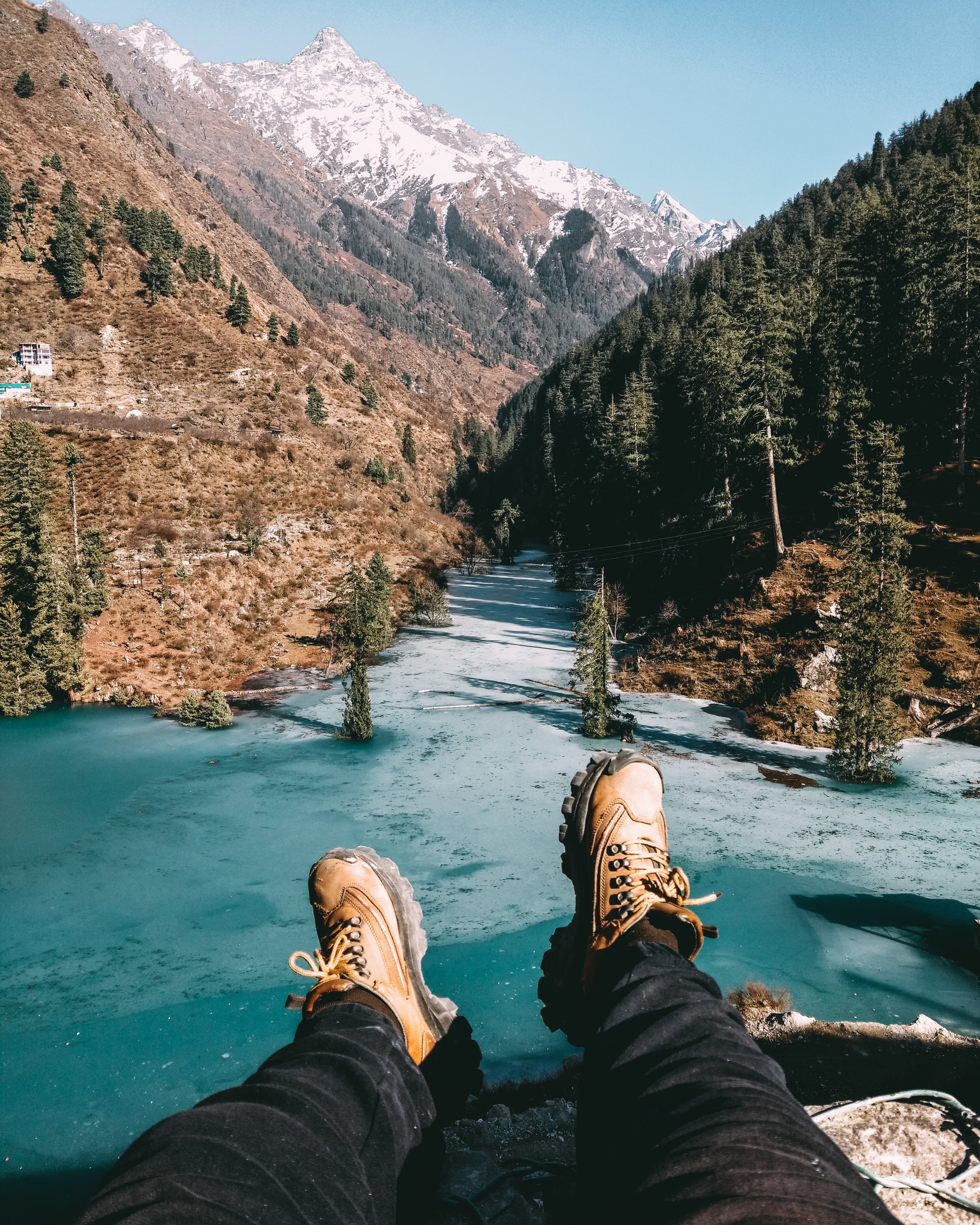 hiking-shoes-reach-out-to-a-cold-aqua-lake-and-rocky-mountians.jpg